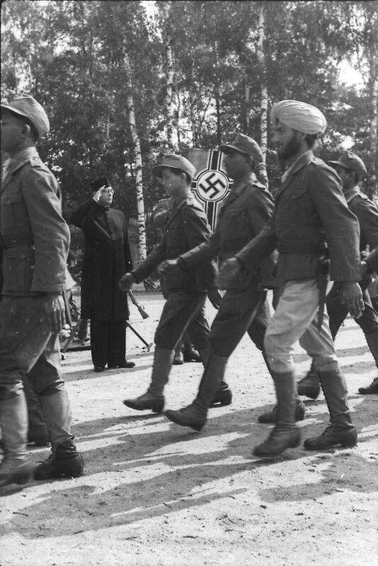 The picture shows 8 POWs turned soldiers marching past Netaji Subhas Chandra Bose.
