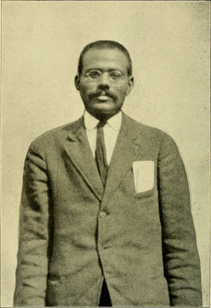 A photo portrait of Lala Har Dayal in a suit with moustache and glasses.
